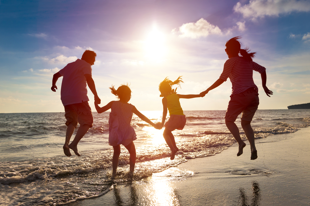 Family jumping near the sea